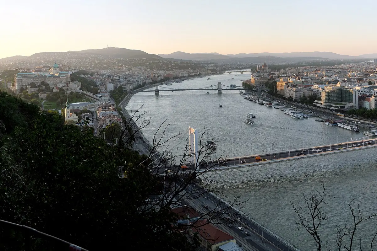 The Danube seen from Gellért Hill at dusk, with the hilly Buda bank and its castle on the left and the flat Pest bank on the right
